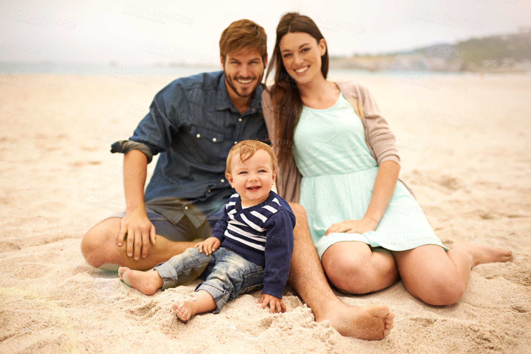 Buy stock photo Portrait, holiday and family with smile in beach, mother and father together with cute baby boy for love. Relax, mom and dad as parents to toddler in nature, growth and development for child outdoor