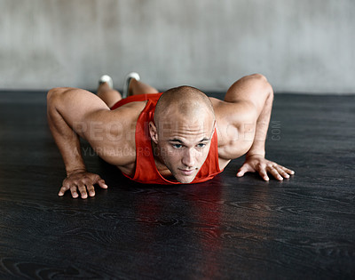 Buy stock photo Shot of a man doing a challenging workout at the gym