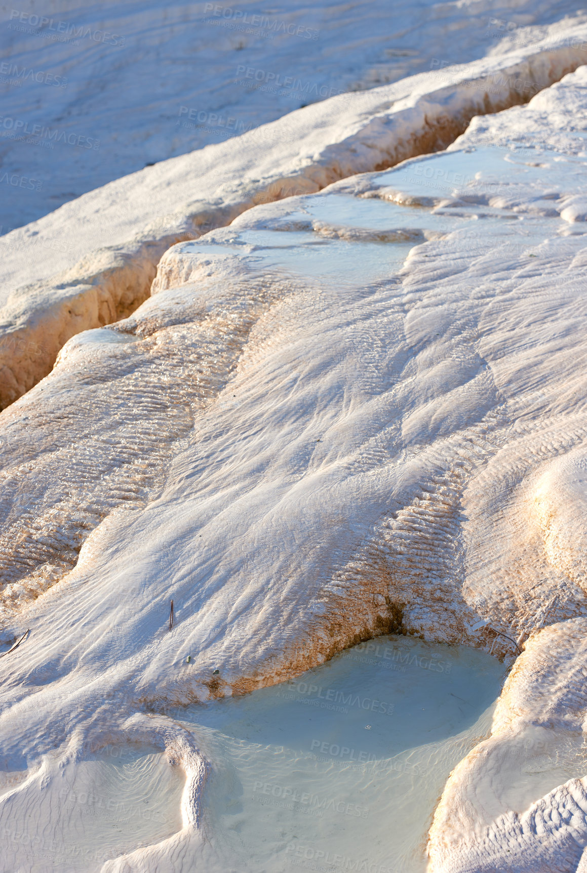 Buy stock photo Closeup of travertine pools and terraces in Pamukkale, Turkey. White desert sand with curvy pattern textures. Tourism holiday destination at rock cotton castle area with mineral flowing spring water