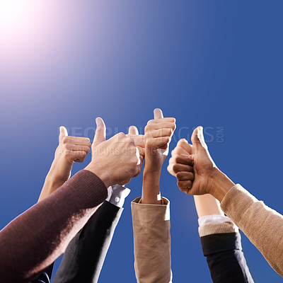 Buy stock photo Cropped shot of businesspeople showing thumbs up against a blue background