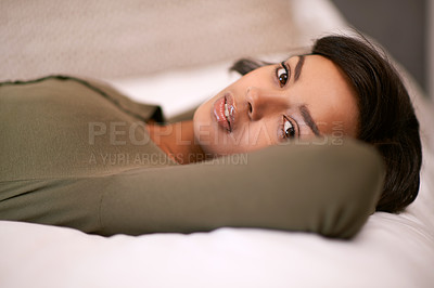 Buy stock photo Bed, lying and woman in portrait in hotel for resting, relaxing and comfortable in weekend vacation. Apartment, bedroom and female person on holiday for wellness, wellbeing and personal break