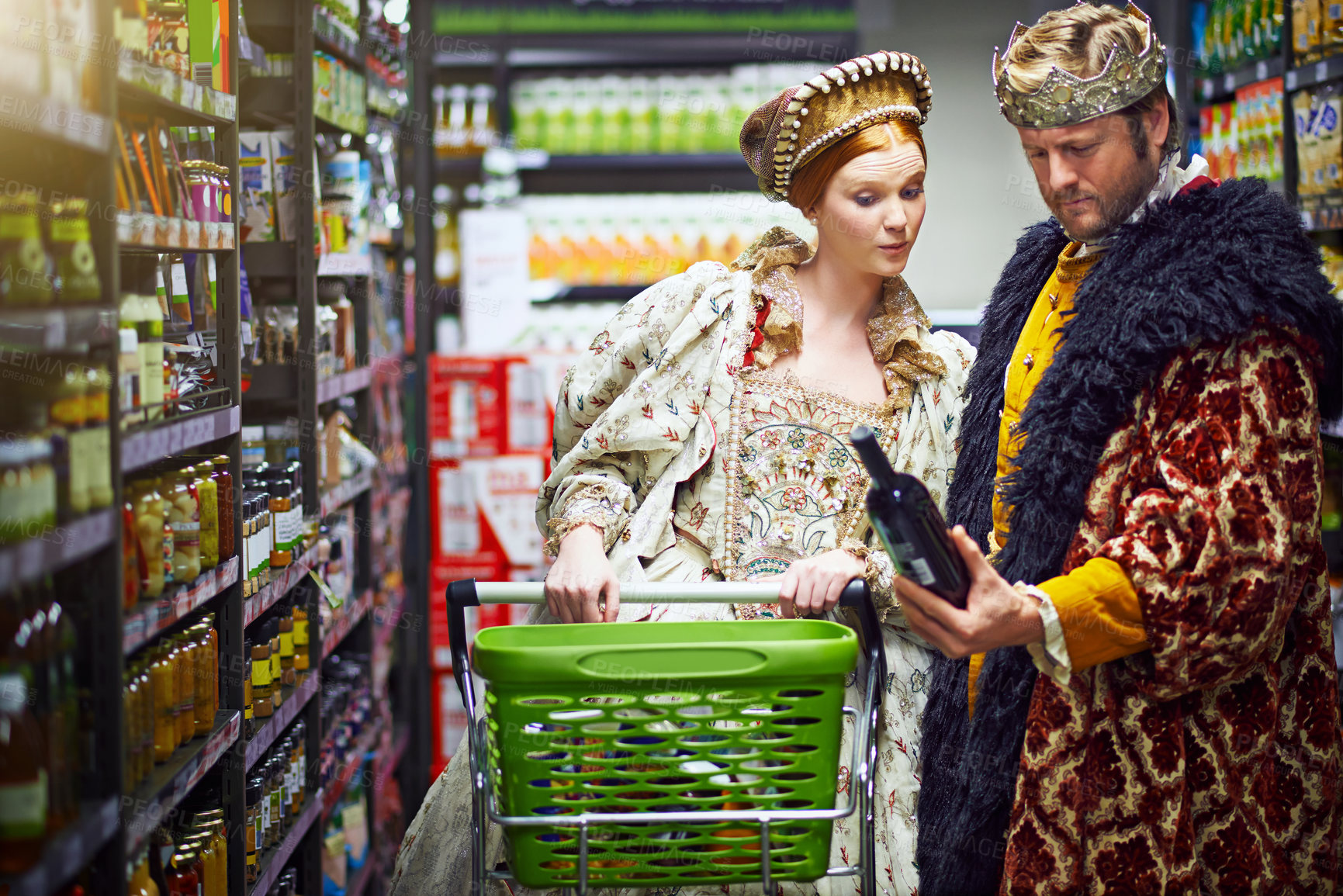 Buy stock photo Shot of a king and queen looking at goods while shopping in a modern grocery store