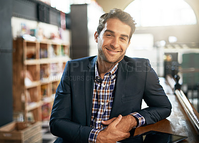 Buy stock photo Portrait, relax and happy with a man in a coffee shop, sitting at a bar counter as a customer during the day. Cafe, smile and fashion with a handsome young male consumer in a trendy restaurant