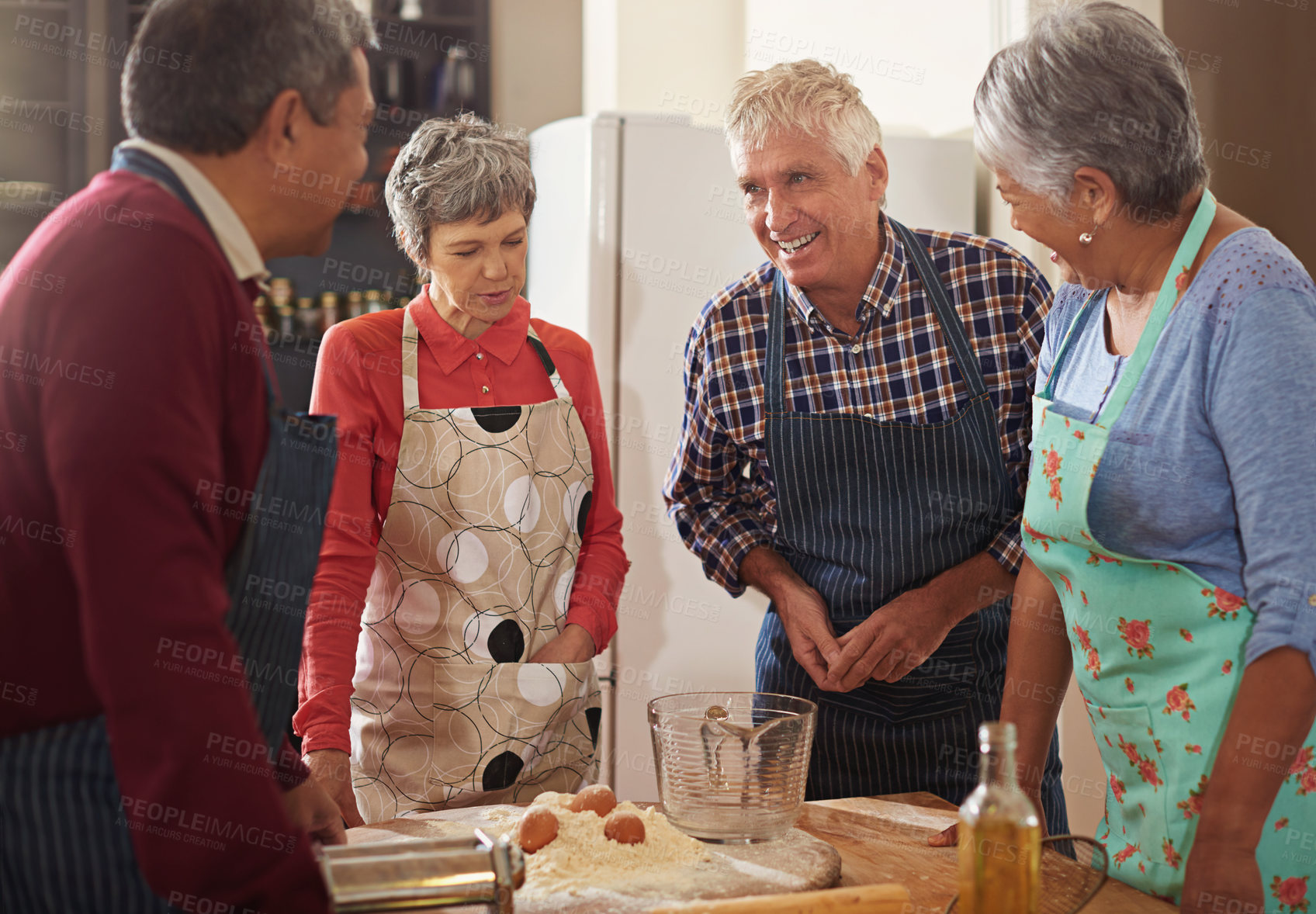 Buy stock photo Shot of a group of seniors cooking in the kitchen