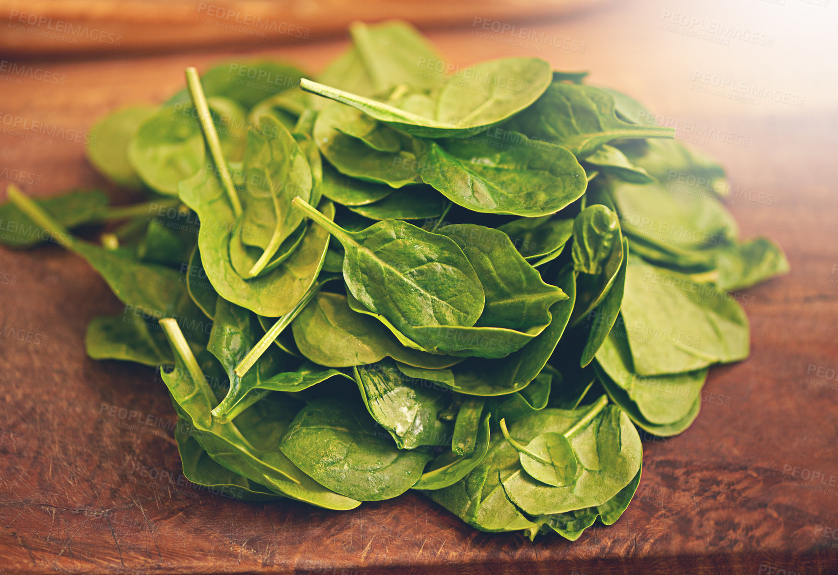 Buy stock photo Shot of fresh basil leaves on a kitchen tabletop