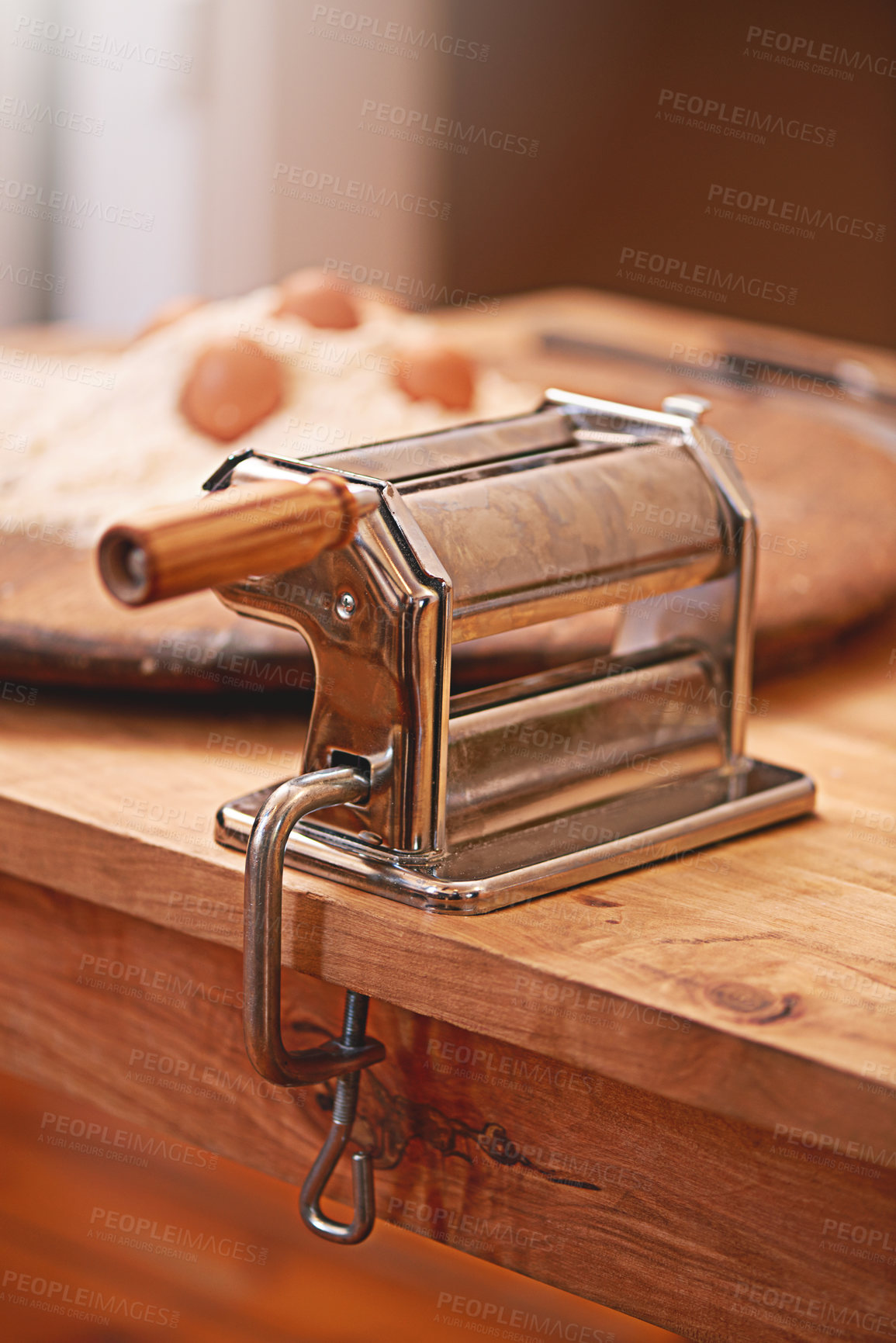 Buy stock photo Cooking, dough and pasta maker in kitchen on table, counter and wooden board for cuisine. Food, baking and culinary tool, machine or utensil for flour, ingredients and eggs for homemade noodles