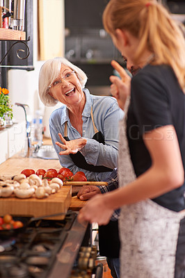 Buy stock photo Woman, grandmother and cooking together in kitchen or teach recipe, prepare dinner or cook lunch with family. Senior mother, girl and conversation in home or talking about food or healthy vegetables