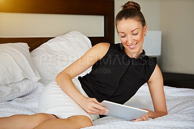 Buy stock photo Shot of a young woman using a digital tablet in her room