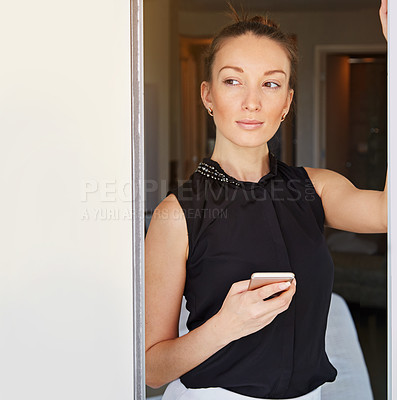 Buy stock photo Shot of a young woman using her cellphone in her hotel room