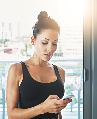 Buy stock photo Cropped shot of a young woman using her cellphone in a hotel room