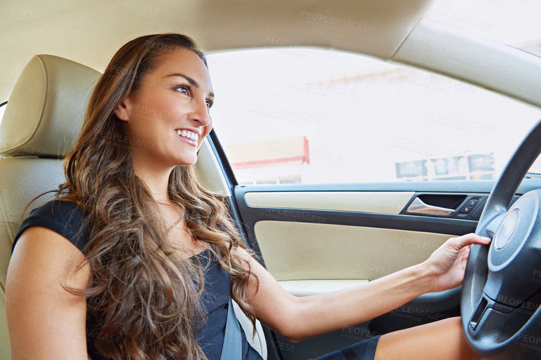 Buy stock photo Cropped shot of a young woman driving her car