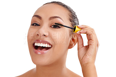 Buy stock photo Studio shot of a beautiful young woman applying mascara against a white background