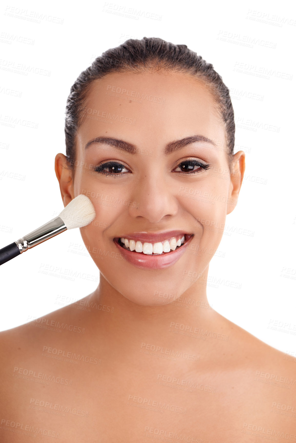 Buy stock photo Studio shot of a beautiful young woman applying blush to her cheeks