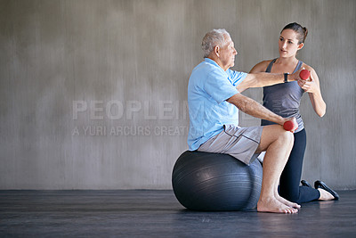 Buy stock photo Physical therapy, dumbbells and senior man on ball for fitness, rehabilitation or exercise at gym on mockup. Elderly person, weightlifting and training with physiotherapist for help or body health