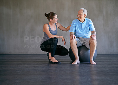 Buy stock photo Exercise ball, talking and physiotherapist with patient for muscle exercise consultation at clinic. Physical therapy, consultation and healthcare worker helping senior man at rehabilitation center.