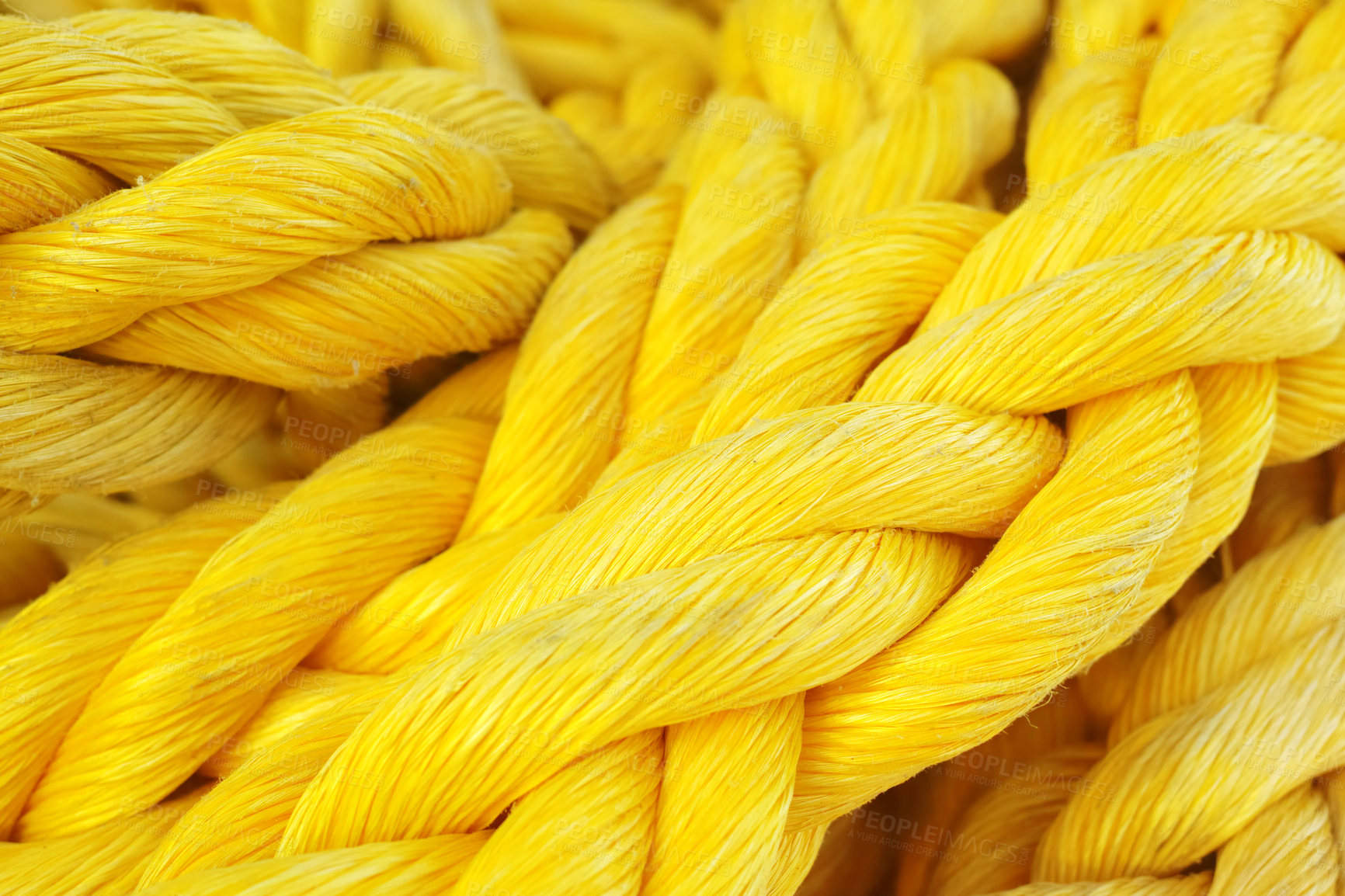 Buy stock photo Closeup of a strong and colorful yellow rope. New heavy duty marine ropes on a sailing vessel. Macro of bright yellow color synthetic rope. Texture of twisted or braided polypropylene rope, copyspace