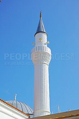 Buy stock photo Architect, Islam and religion with Minaret outdoor in Bodrum, Turkey for prayer or worship. Arabic, belief and tower with Muslim building on blue sky for culture, faith or tradition in Europe