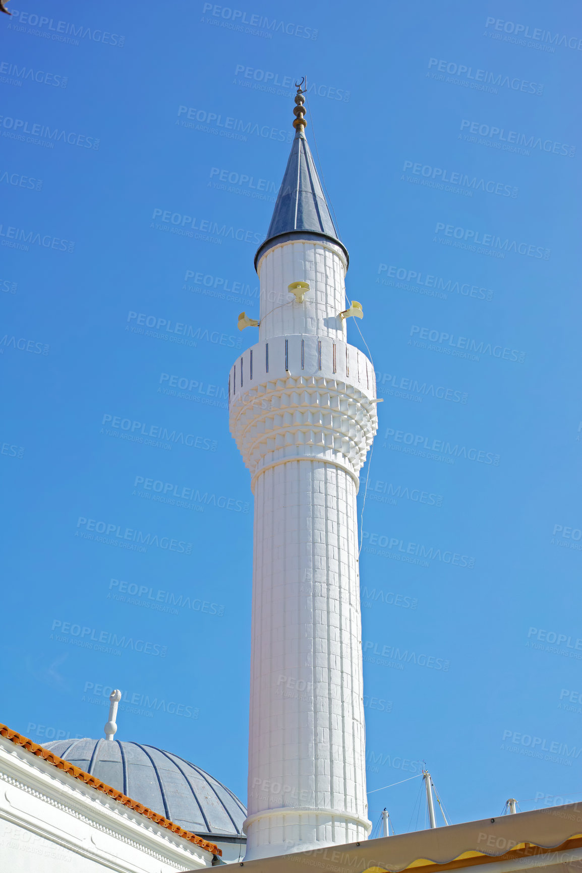 Buy stock photo Architect, Islam and religion with Minaret outdoor in Bodrum, Turkey for prayer or worship. Arabic, belief and tower with Muslim building on blue sky for culture, faith or tradition in Europe