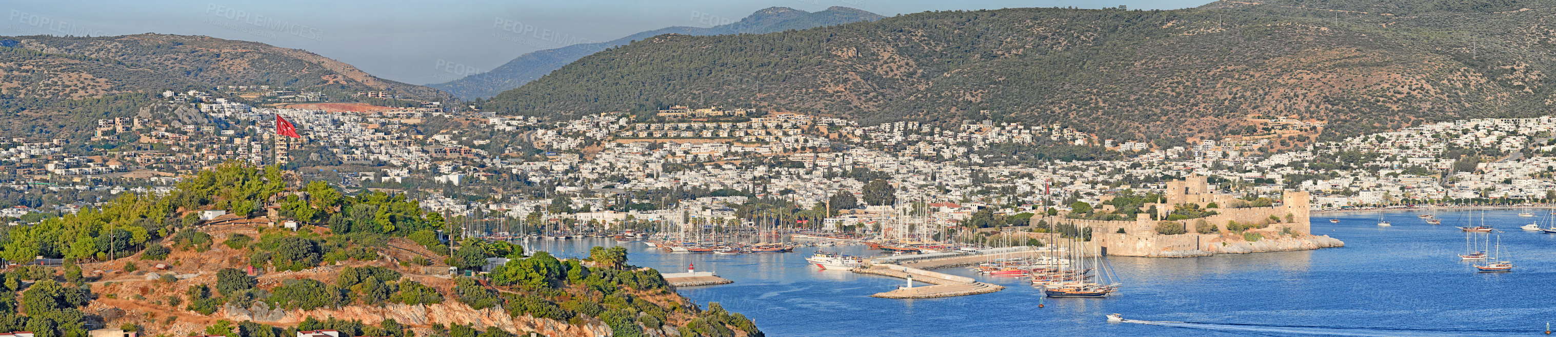 Buy stock photo Panorama view of city and hills in romantic harbor of Bodrum in Turkey during the day. Scenic landscape view of sailing yachts in cruise port and bay. Tourism abroad, overseas in Aegean sea dockyard