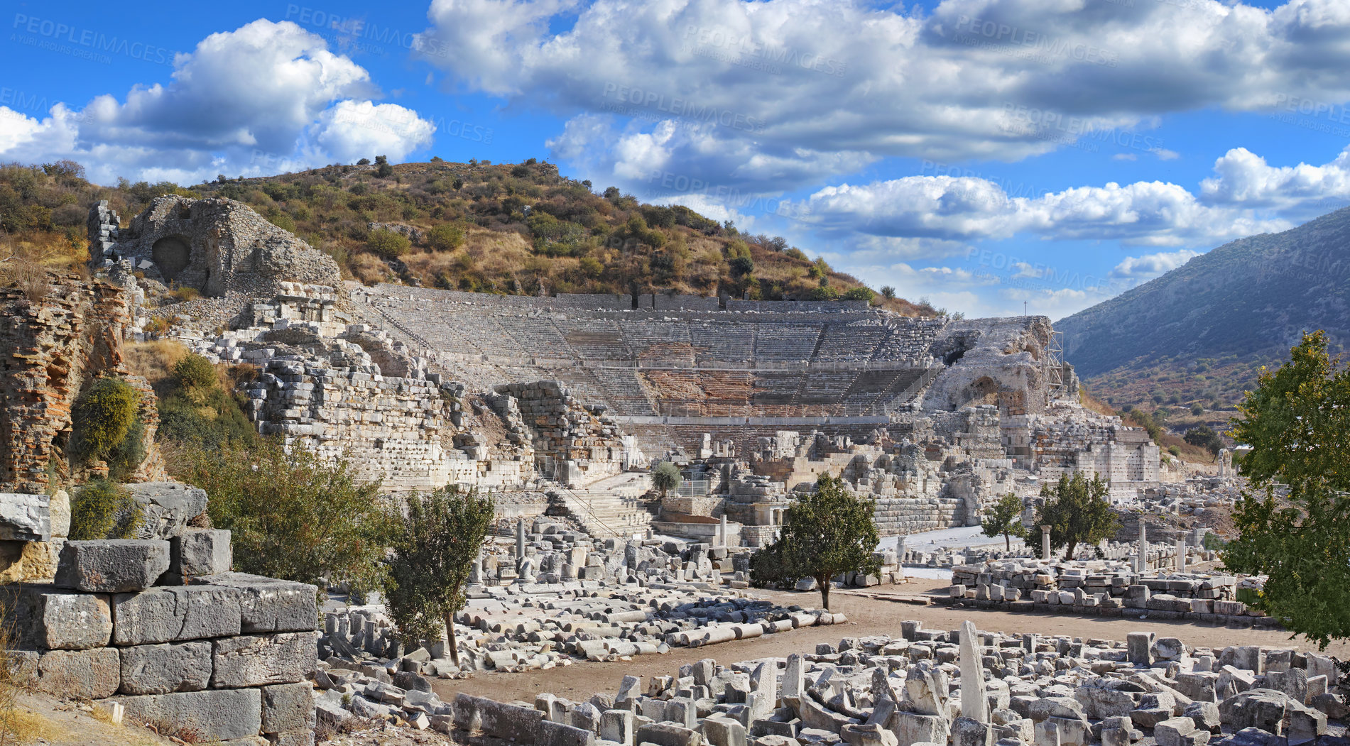 Buy stock photo Ancient city ruins of Ephesus in Turkey surrounded by nature. Popular tourism attraction of the remains of well preserved historical stone building from classical greek and roman history and culture