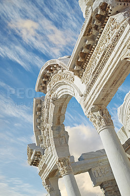 Buy stock photo Historical Turkey Ephesus arch in an ancient city. Closeup of a keystone arch with architectural detail and patterns. Ruin of ancient roman archway temple outside under a blue sky with light clouds