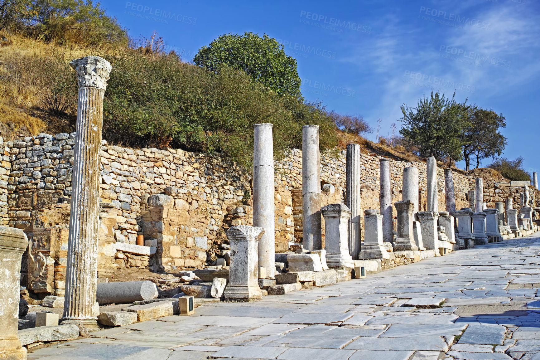 Buy stock photo Historical Turkey pillars Ephesus in an ancient city. Excavated remains of historical building stone in Turkish history and culture. Ruin of ancient roman architecture in a popular tourism attraction