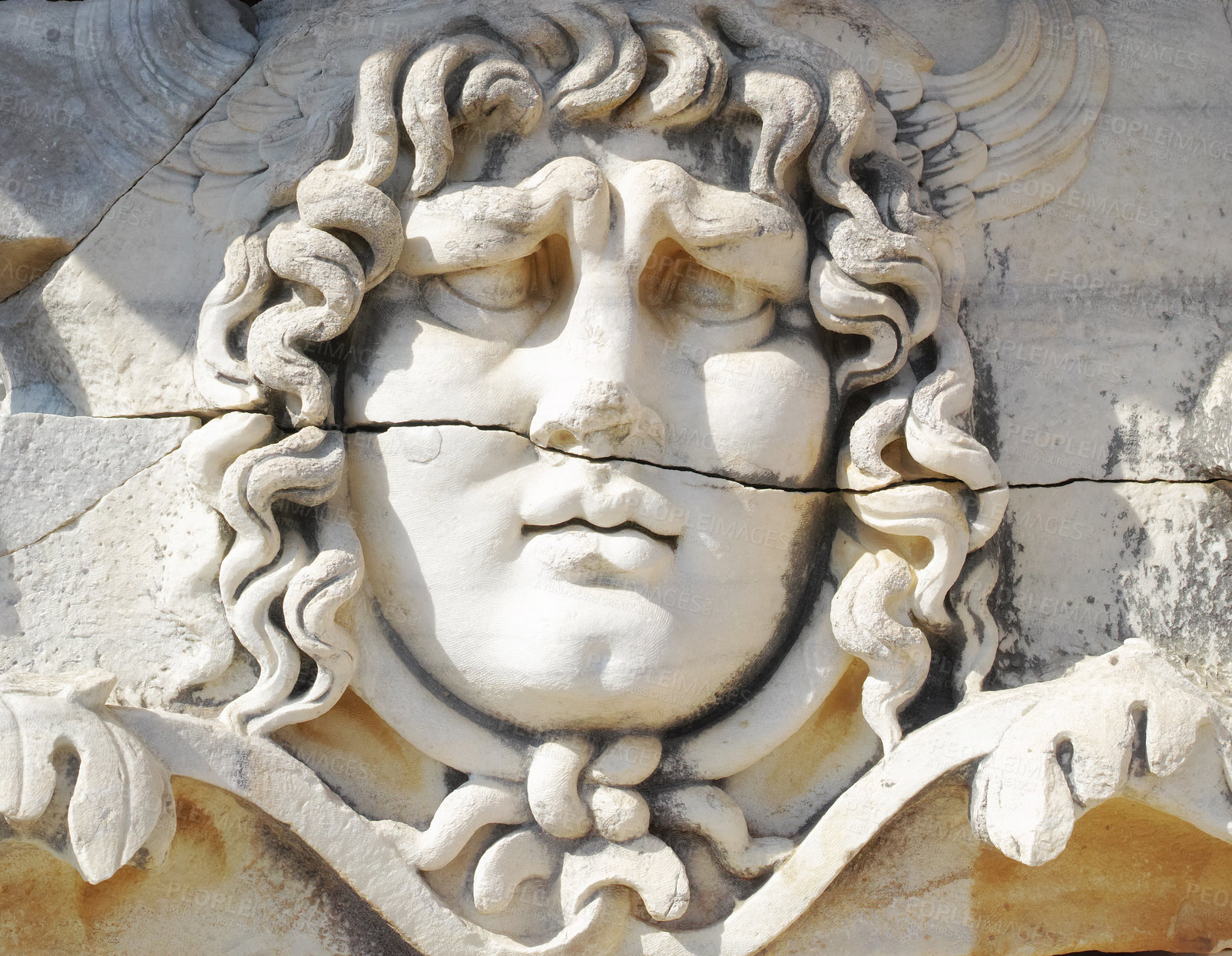 Buy stock photo Closeup of a face carved on marble in classical style by ancient Greeks at the Temple of Apollo in Didyma. An impressive ruined sanctuary or statue in Hellenic city of Miletus, in southwest Turkey