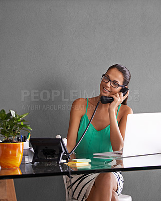 Buy stock photo Phone call, remote work and landline with woman in office for communication or reception. Laptop, thinking and smile with happy young secretary answering telephone in small business or startup