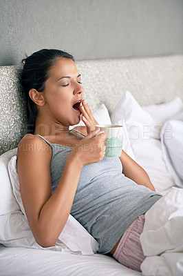 Buy stock photo Woman, relax and tea in morning with yawn for waking up, tired and exhausted in home. Female person, bed and sleepy gesture with coffee mug in apartment for weekend, day off and beverage on pillow