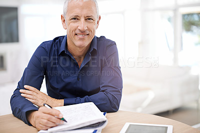 Buy stock photo Portrait of a mature man using a digital tablet at home