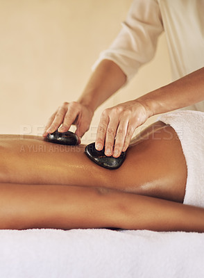 Buy stock photo Woman, relax and hands with rocks at spa for lomi lomi massage, treatment or skincare and wellness. Female person, therapist or masseuse with hot stones for shoulder, muscle and holistic care