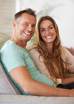Buy stock photo Couple, portrait with smile and love in marriage, life partner with support and relax together for bonding at home. People on sofa, trust and care for commitment, loyalty and respect with happiness