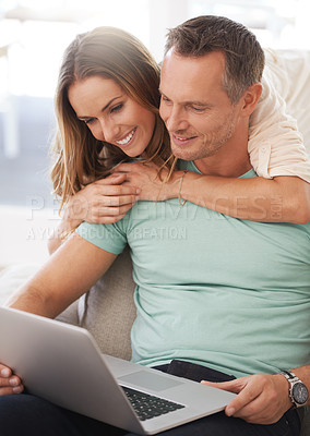 Buy stock photo Laptop, sofa and happy couple with home internet for online planning, website review and check application together. Hug, love and affection of mature woman, partner or people on computer technology