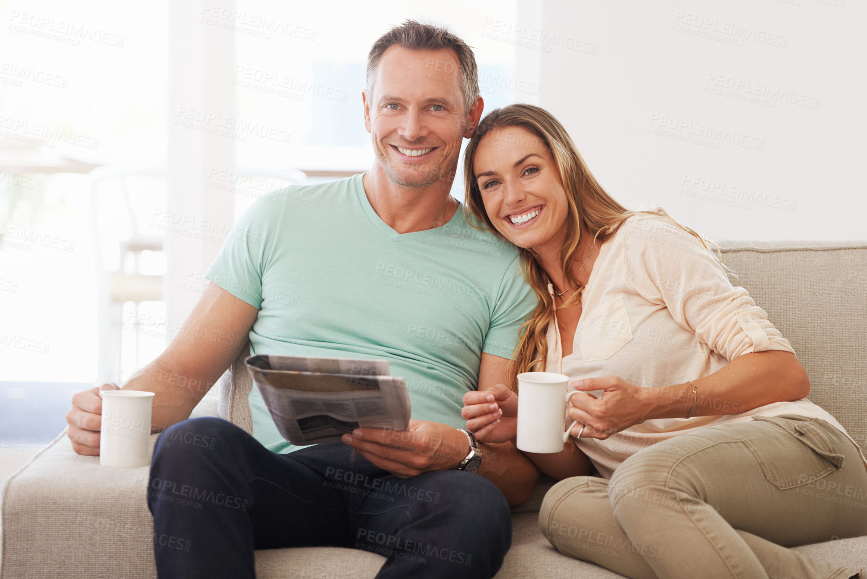 Buy stock photo Newspaper, portrait and happy couple on sofa with love, tea and affection at home for holiday home or vacation with news. Mature partner, woman or people on couch together smile with paper and coffee