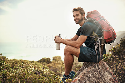 Buy stock photo Shot of a young man taking a water break while out hiking
