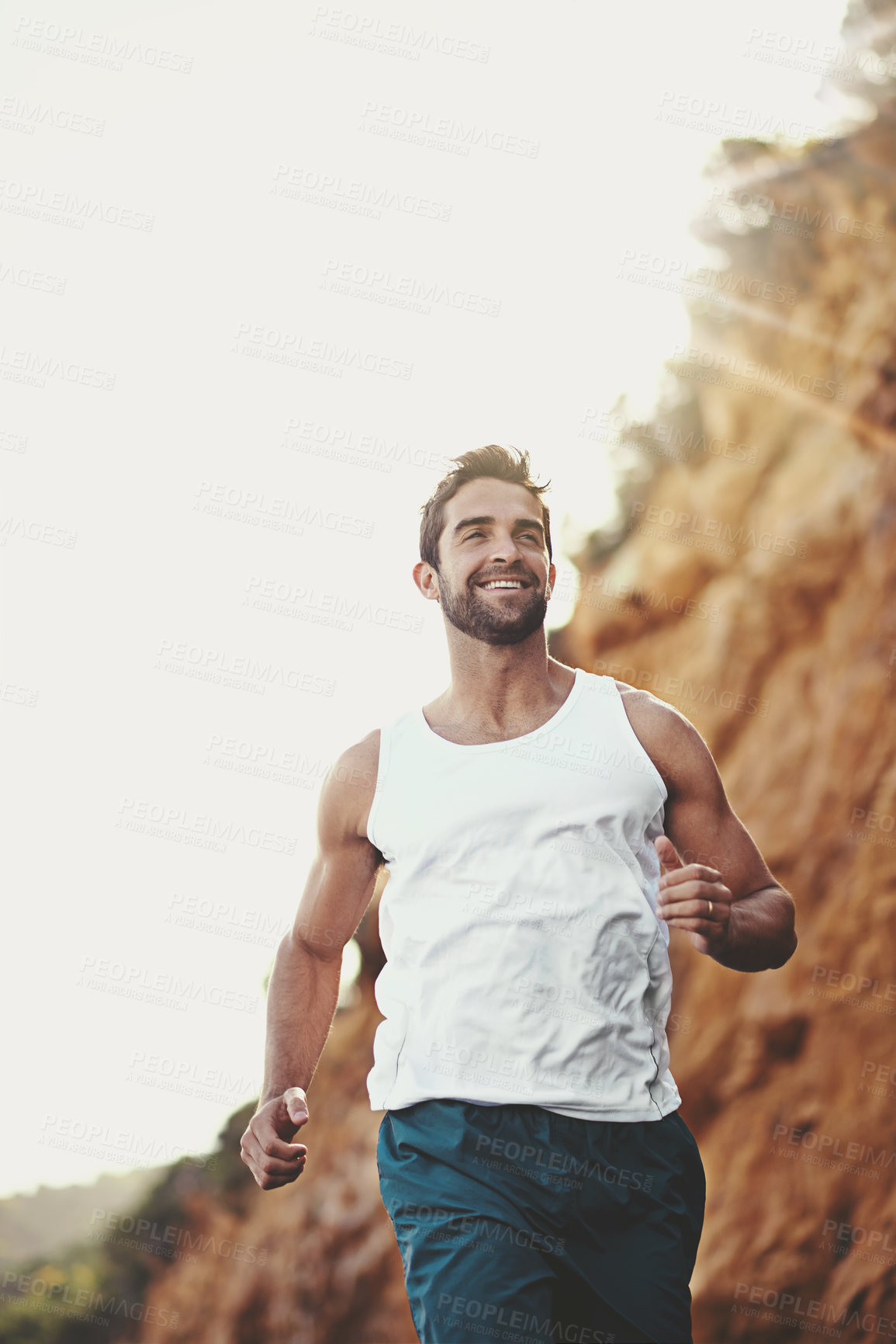 Buy stock photo Man, runner and athlete for outdoor workout, sports and nature for cardio or training for marathon. Male person, happy and fitness on mountain for performance challenge, health and exercise for race