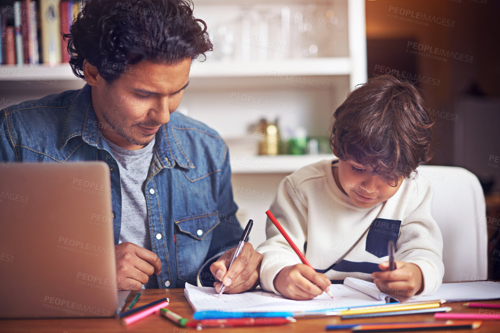 Buy stock photo Shot of a father helping his son with his homework