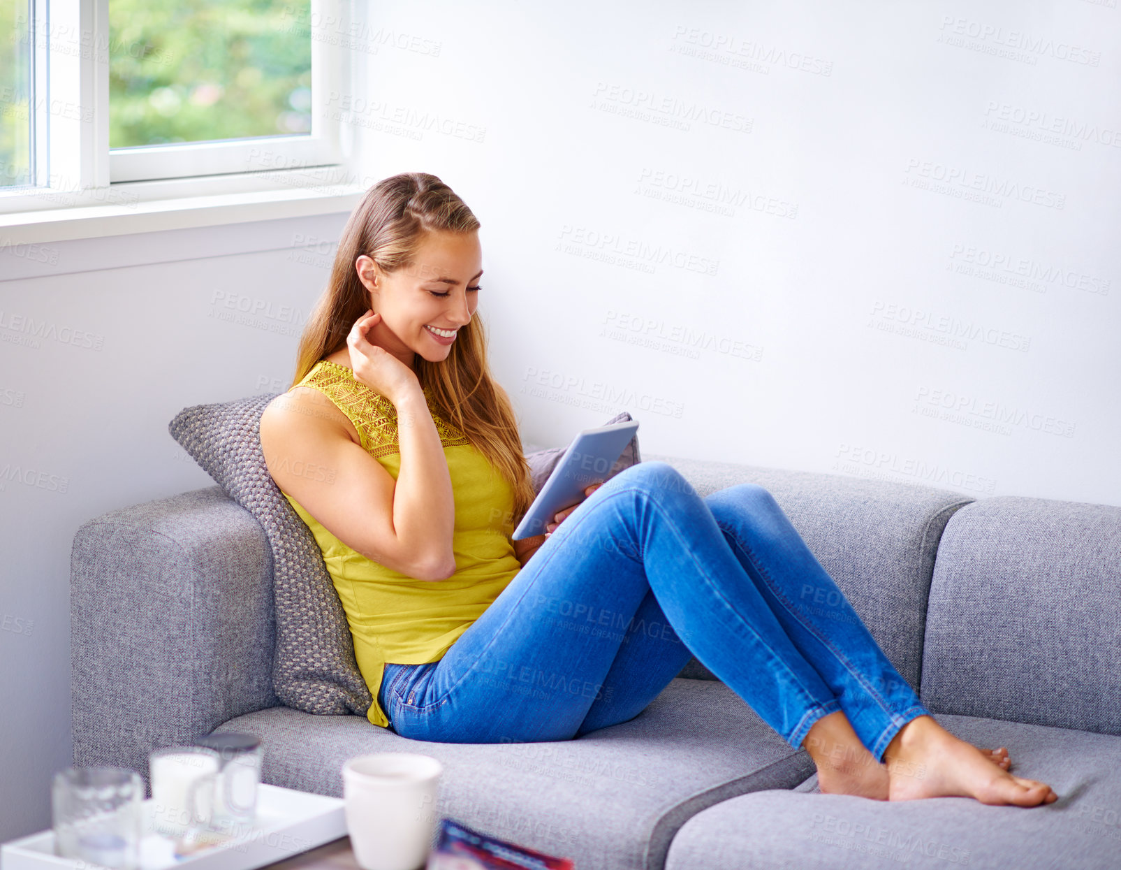 Buy stock photo Woman, relax and tablet on sofa at house for reading online blog, website and browsing social media with internet in living room. Smile, female person and scroll on digital tech for streaming videos 