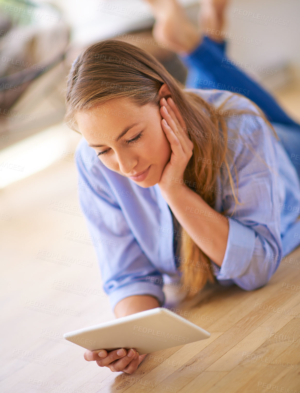 Buy stock photo Casual, woman and tablet lying on floor for streaming, social media post or communication in home. Female person, tech or connection in house relax for online research, internet news or blog