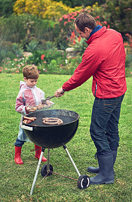 Buy stock photo Shot of a family having a barbecue outside