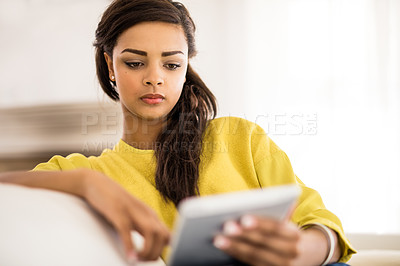 Buy stock photo Woman, tablet and scroll on sofa with online streaming service, reading and ebook app at home for leisure. Young person or user with digital technology for website, information or internet on weekend