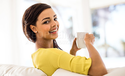 Buy stock photo Shot of an attractive young woman having coffee at home