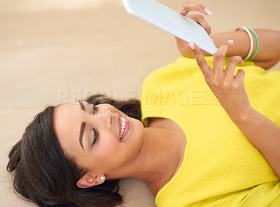 Buy stock photo Woman, tablet and internet on floor for entertainment with streaming music, watching movies and relaxing. Technology, online and girl in house for pleasure, enjoyment and social media communication