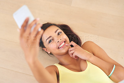 Buy stock photo Above, lay on floor and taking selfie for teenage girl with smile for social media post on holiday break for online memories. Young person or generation z and playful with mobile for photo capture
