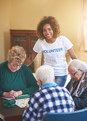 Buy stock photo Shot of a volunteer working with seniors at a retirement home