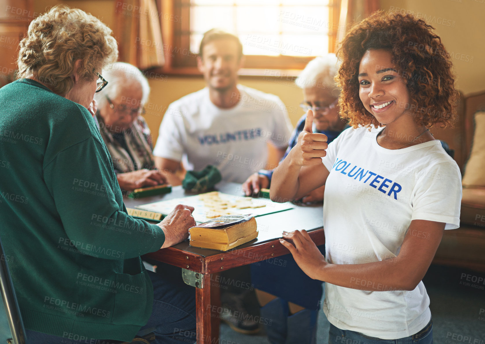 Buy stock photo Portrait of volunteers working with seniors at a retirement home
