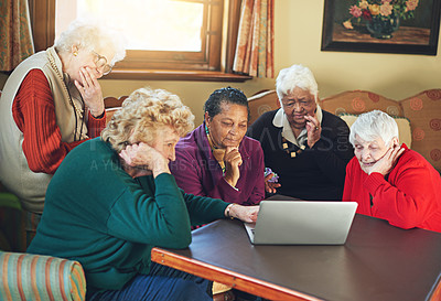 Buy stock photo Shot of a group of senior women using a laptop at a senior centre