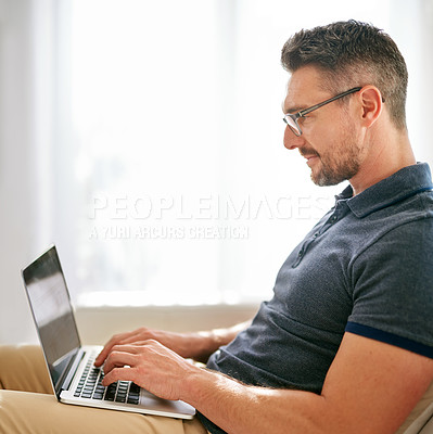 Buy stock photo Laptop, research and social media with man on sofa in living room of home for internet browsing or surfing. Computer, relax and technology with person online for information search in apartment