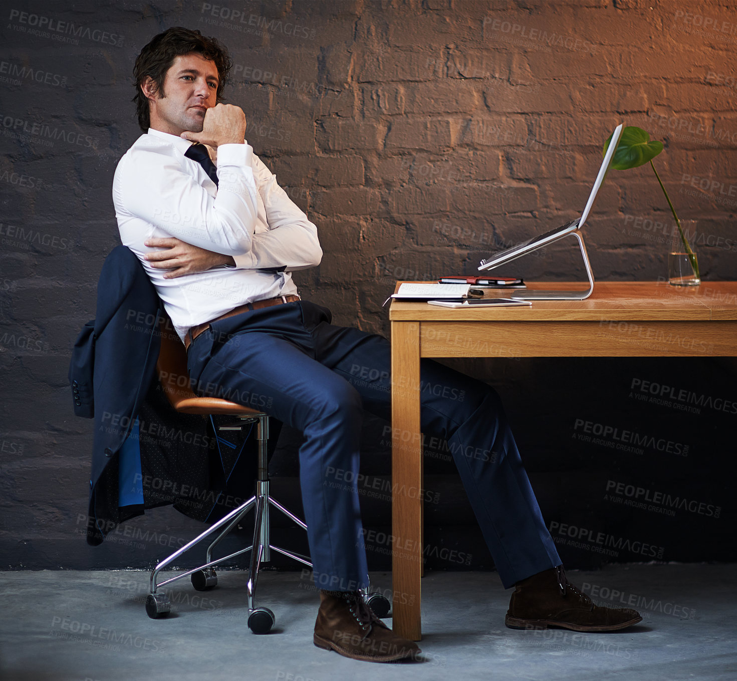 Buy stock photo Thinking, laptop and businessman in office at night with ideas for investigation with research. Planning, computer and male detective work on criminal justice case for filing deadline by brick wall.