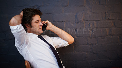 Buy stock photo Cropped shot of a businessman talking on his cellphone in the office